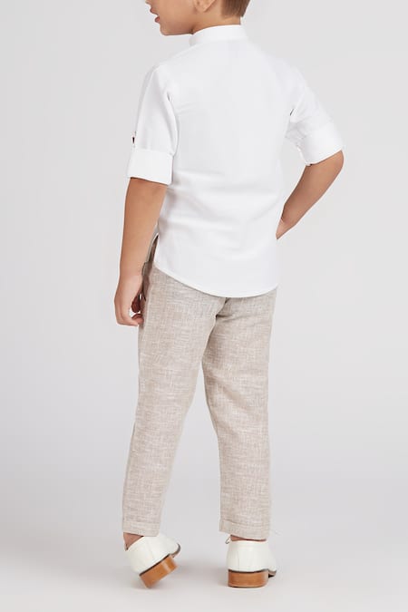 Shop Petite Pomme White Cotton, Linen Boys Short Kurta Set With Beige Pants at Aza Fashions Shop_Petite Pomme_White Cotton, Linen Boys Short Kurta Set With Beige Pants _at_Aza_Fashions