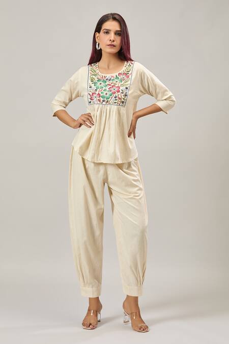 Naintara Bajaj Off White Cotton Embroidery Round Neck Peplum Top And Balloon Pant Set at Aza Fashions Naintara Bajaj_Off White Cotton Embroidery Round Neck Peplum Top And Balloon Pant Set _at_Aza_Fashions