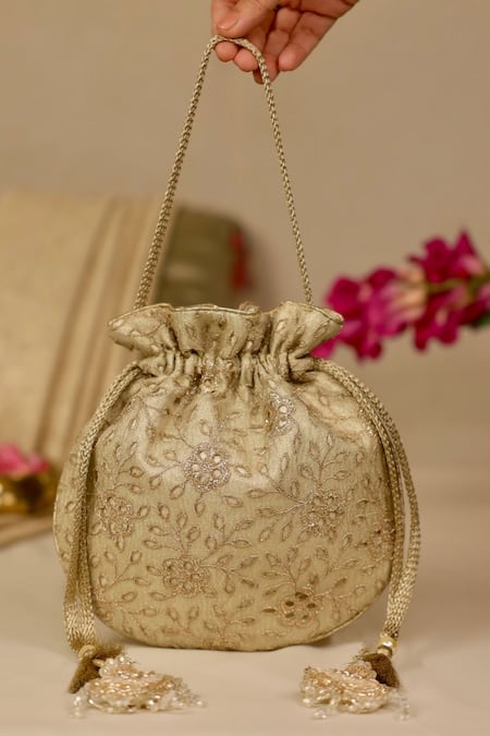 Amyra_Gold Embroidery, Tassels Tarang Cutwork Potli Bag_Online_at_Aza_Fashions