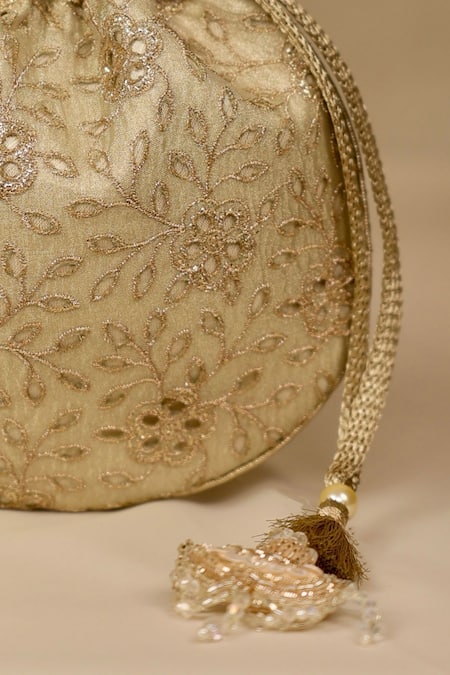 Amyra_Gold Embroidery, Tassels Tarang Cutwork Potli Bag_at_Aza_Fashions