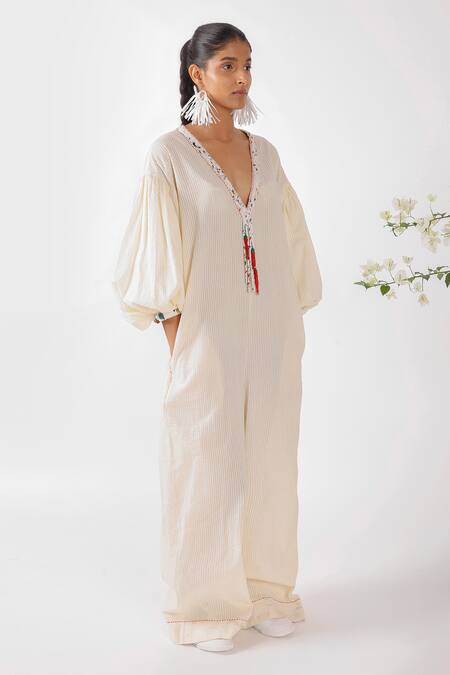 Buy Nikasha Cream Cotton Tassels, Embroidery V-neck Chilly Seersucker Jumpsuit Online at Aza Fashions Buy_Nikasha_Cream Cotton Tassels, Embroidery V-neck Chilly Seersucker Jumpsuit _Online_at_Aza_Fashions