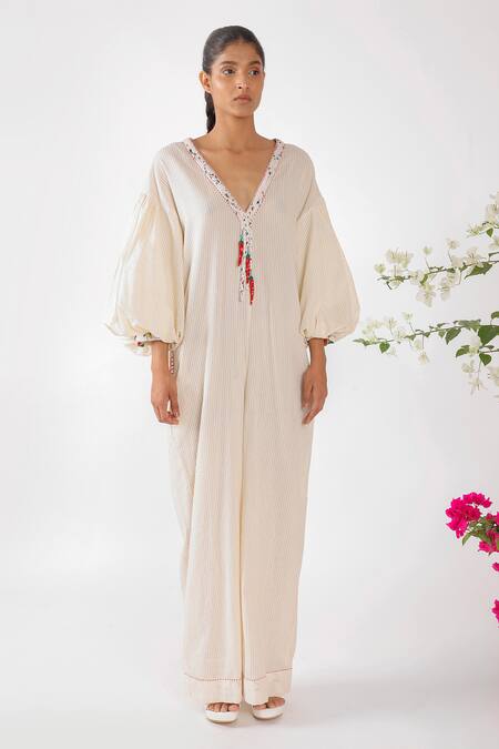 Nikasha Cream Cotton Tassels, Embroidery V-neck Chilly Seersucker Jumpsuit at Aza Fashions Nikasha_Cream Cotton Tassels, Embroidery V-neck Chilly Seersucker Jumpsuit _at_Aza_Fashions