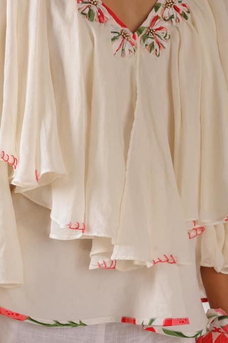 Nikasha_Ivory Cotton Embroidery V-neck Ruffle Top With Ribbon_at_Aza_Fashions