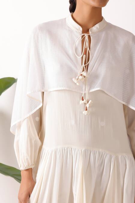 Nikasha_Cream Cotton Fabric Flowers Round Neck Jamdani Godet Cape Dress_at_Aza_Fashions