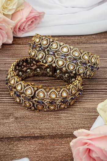 Shop Vivinia By Vidhi Mehra Gold Plated Imitation Diamonds And Purple Kundan Polki Bangles at Aza Fashions Shop_Vivinia By Vidhi Mehra_Gold Plated Imitation Diamonds And Purple Kundan Polki Bangles _at_Aza_Fashions