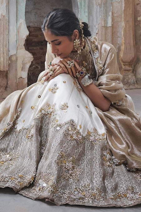 Etasha By Asha Jain Ivory Silk, Tissue Sequins, Embroidery Halter Neck And Gold Lehenga Set at Aza Fashions Etasha By Asha Jain_Ivory Silk, Tissue Sequins, Embroidery Halter Neck And Gold Lehenga Set _at_Aza_Fashions