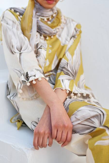 Buy Rainas Mustard Cotton, Linen Pom-poms Round Neck Bloom Kurta Pant Set Online at Aza Fashions Buy_Rainas_Mustard Cotton, Linen Pom-poms Round Neck Bloom Kurta Pant Set _Online_at_Aza_Fashions