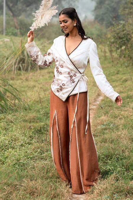 Kushani Ivory Satin, Linen Embroidery V-neck Wrap Top And Mocha Brown Trousers at Aza Fashions Kushani_Ivory Satin, Linen Embroidery V-neck Wrap Top And Mocha Brown Trousers _at_Aza_Fashions