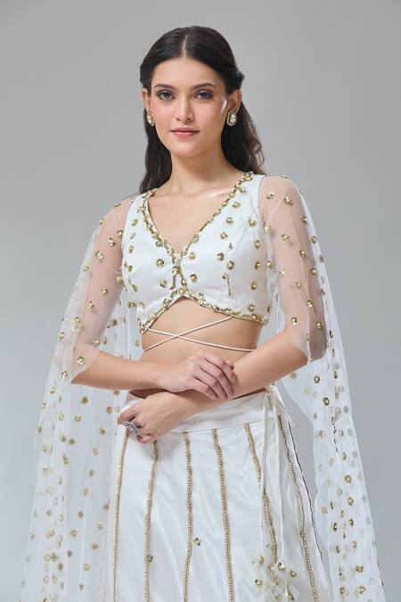 Divya Kanakia_Ivory Net, Silk Satin Sequins, Embroidery V-neck Lehenga And Blouse Set _at_Aza_Fashions
