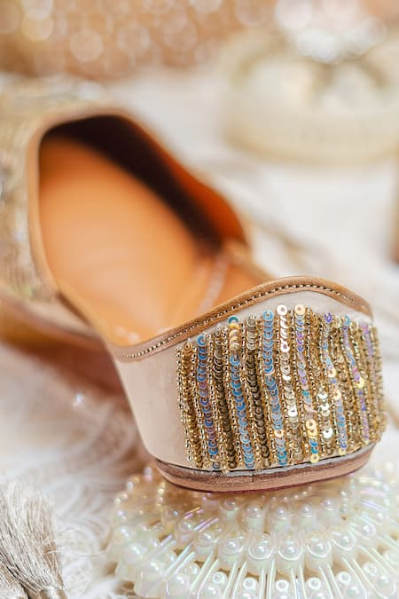 Shop_NR By Nidhi Rathi_Gold Gold-toned Embroidered Flat Juttis _Online_at_Aza_Fashions