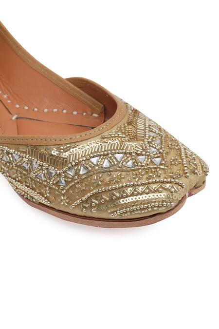 Shop_NR By Nidhi Rathi_Gold Gold-toned Embroidered Flat Juttis _Online_at_Aza_Fashions