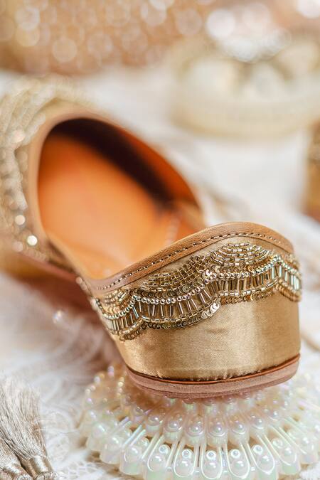NR By Nidhi Rathi_Gold Gold-toned Embroidered Flat Juttis _at_Aza_Fashions