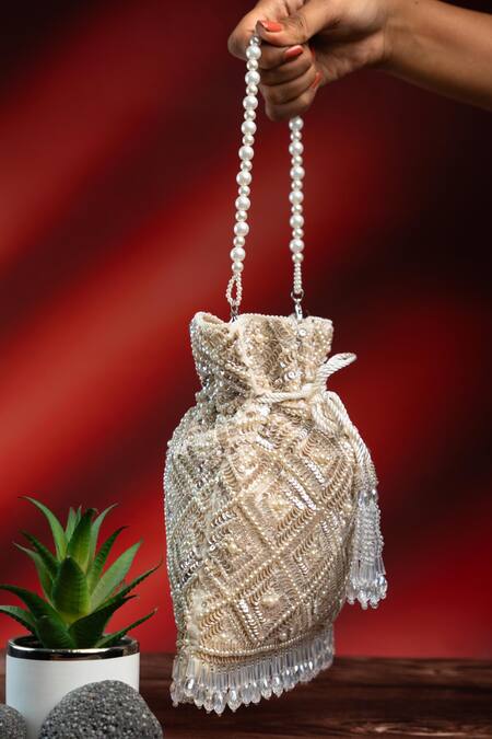 Nayaab By Sonia Off White Pearls, Rhinestones, Embroidery, Crystals Criss Cross Ivory Potli Online at Aza Fashions Nayaab By Sonia_Off White Pearls, Rhinestones, Embroidery, Crystals Criss Cross Ivory Potli _Online_at_Aza_Fashions