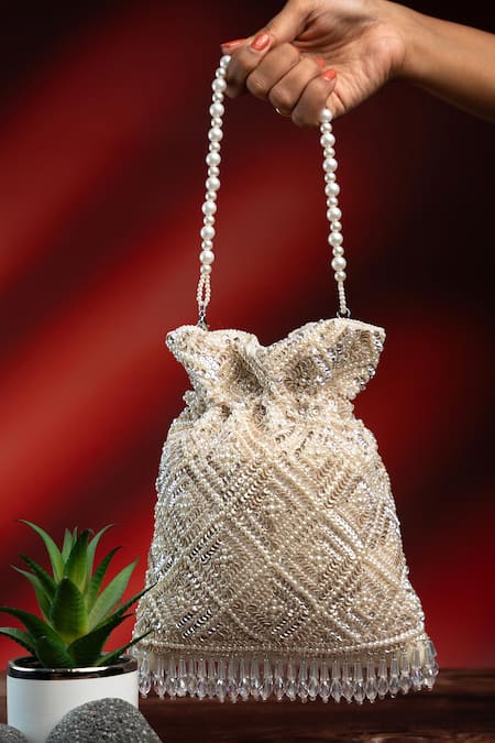 Shop Nayaab By Sonia Off White Pearls, Rhinestones, Embroidery, Crystals Criss Cross Ivory Potli at Aza Fashions Shop_Nayaab By Sonia_Off White Pearls, Rhinestones, Embroidery, Crystals Criss Cross Ivory Potli _at_Aza_Fashions