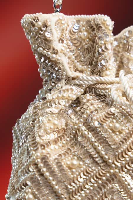 Shop Nayaab By Sonia Off White Pearls, Rhinestones, Embroidery, Crystals Criss Cross Ivory Potli Online at Aza Fashions Shop_Nayaab By Sonia_Off White Pearls, Rhinestones, Embroidery, Crystals Criss Cross Ivory Potli _Online_at_Aza_Fashions