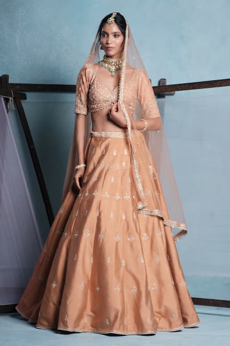 Muditaa By Urmila Peach Dupion, Net Embroidery, Tassels, Crystals, Sequins V-neck Ira Lehenga Set 
