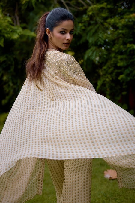 Shop Nikasha Cream Silk Sequins Round , Scoop Janeman Floral Print Cape Pant Set at Aza Fashions Shop_Nikasha_Cream Silk Sequins Round , Scoop Janeman Floral Print Cape Pant Set _at_Aza_Fashions