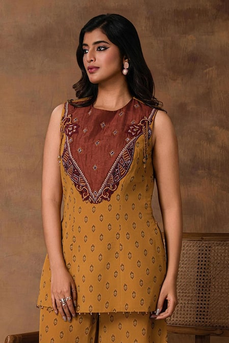 ISHA GUPTA TAYAL_Mustard Crepe Embroidery Round Neck Gold Peplum Top And Pant Set _Online_at_Aza_Fashions