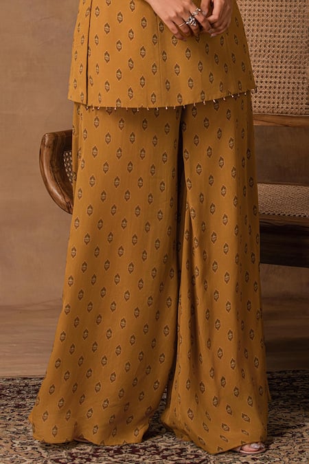 Buy_ISHA GUPTA TAYAL_Mustard Crepe Embroidery Round Neck Gold Peplum Top And Pant Set _Online_at_Aza_Fashions