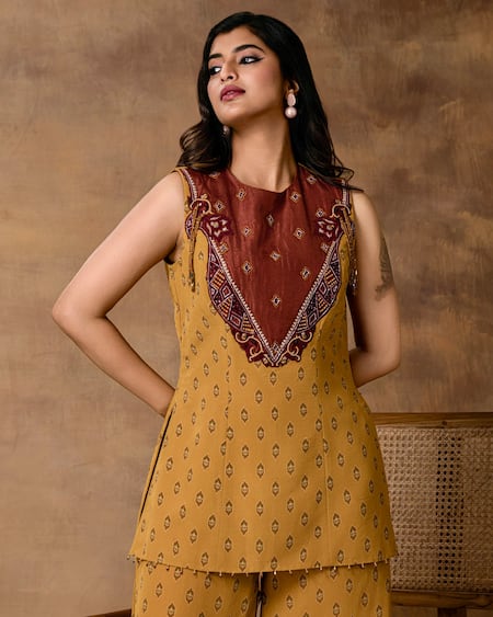 ISHA GUPTA TAYAL_Mustard Crepe Embroidery Round Neck Gold Peplum Top And Pant Set _at_Aza_Fashions