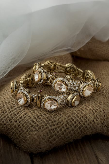 Shop Vivinia By Vidhi Mehra Gold Plated Stones, Rhinestones Asymmetric Embellished Bangles at Aza Fashions Shop_Vivinia By Vidhi Mehra_Gold Plated Stones, Rhinestones Asymmetric Embellished Bangles _at_Aza_Fashions