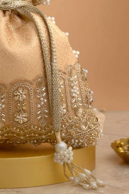 Shop Amyra Peach Cut Work, Pearls, Tassels, Lace Geet Brocade Embellished Potli - Online at Aza Fashions Shop_Amyra_Peach Cut Work, Pearls, Tassels, Lace Geet Brocade Embellished Potli -_Online_at_Aza_Fashions