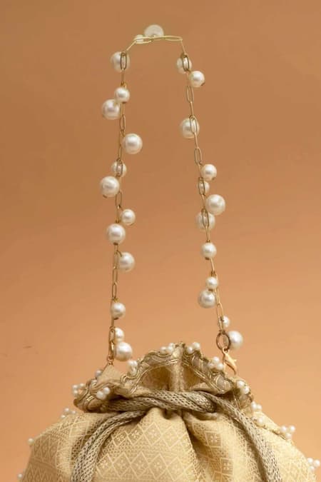 Amyra_Cream Cut Work, Pearls, Tassels, Embroidery Geet Brocade Embellished Potli -_Online_at_Aza_Fashions