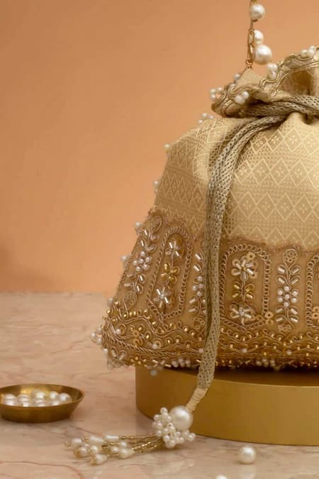 Buy_Amyra_Cream Cut Work, Pearls, Tassels, Embroidery Geet Brocade Embellished Potli -_Online_at_Aza_Fashions