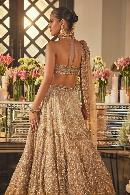 Isa By Dolly Wahal_Gold Net Sequins, Crystals, Embroidery Halter Neck Zara Embellished Lehenga Set _Online_at_Aza_Fashions