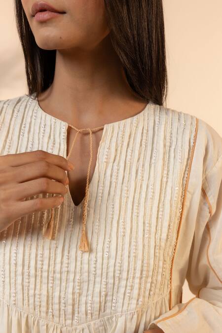 Ourdve Beige Cotton Embroidery, Tassels Split V-neck Sunpetal Gathered Dress at Aza Fashions Ourdve_Beige Cotton Embroidery, Tassels Split V-neck Sunpetal Gathered Dress _at_Aza_Fashions