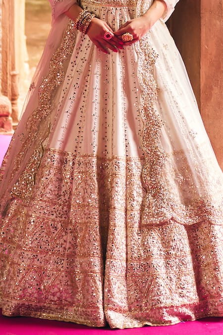 Angad Singh Ivory Silk, Net Mirrors, Zari, Gota Patti, Embroidery Raw Bridal Lehenga Set at Aza Fashions Angad Singh_Ivory Silk, Net Mirrors, Zari, Gota Patti, Embroidery Raw Bridal Lehenga Set _at_Aza_Fashions