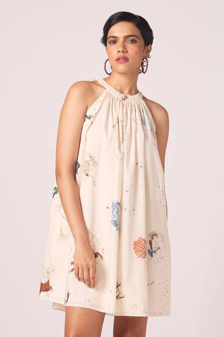 The Summer House_Cream Cambric, Cotton Halter Neck Chica Zodiac Print Short Dress _at_Aza_Fashions