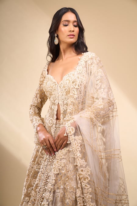 Seema Gujral_Beige Net Pearls, Embroidery, Zari V-neck Jacket Lehenga Set _at_Aza_Fashions