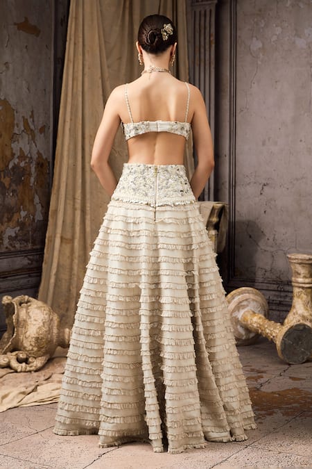 Rocky Star Ivory Net, Silk Sequins, Beads, Ruffles Embellished Blouse And Tiered Lehenga Set Online at Aza Fashions Rocky Star_Ivory Net, Silk Sequins, Beads, Ruffles Embellished Blouse And Tiered Lehenga Set _Online_at_Aza_Fashions