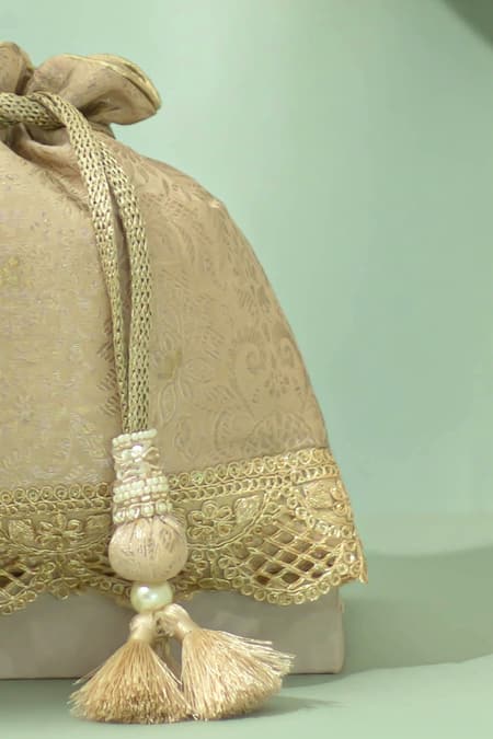 Amyra_Beige Tassels, Beads, Metallic Thread Nira Katan Silk Woven Potli Bag _Online_at_Aza_Fashions