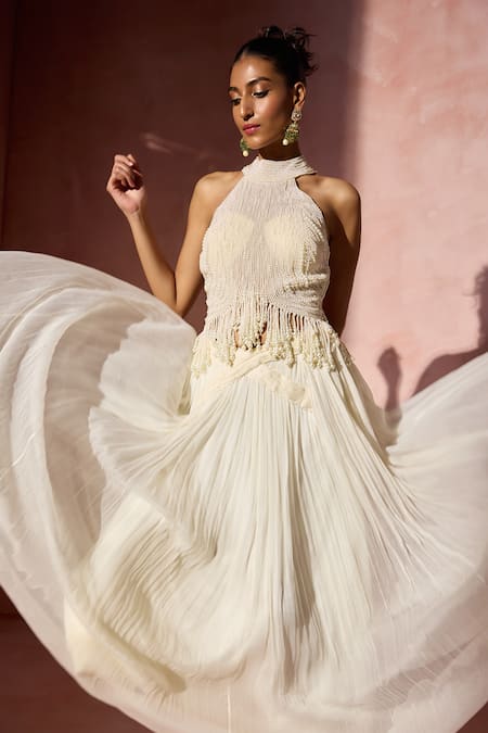 Nitika Gujral Ivory Chiffon, Satin, Organza Pearls, Fringe Halter Pleated Skirt And Blouse Set at Aza Fashions Nitika Gujral_Ivory Chiffon, Satin, Organza Pearls, Fringe Halter Pleated Skirt And Blouse Set _at_Aza_Fashions