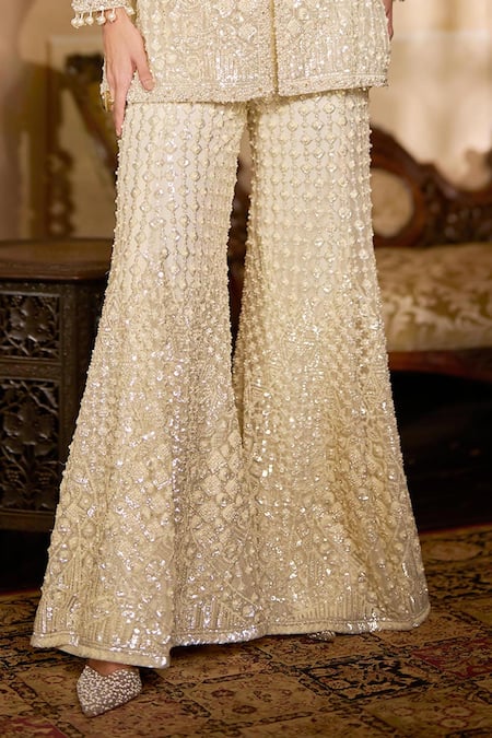 Seema Gujral_Cream Net Sequins, Pearls, Embroidery, Tassels Open Neck, Jacket Sharara Set _at_Aza_Fashions