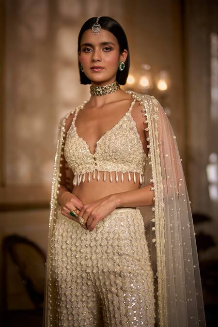 Seema Gujral_Cream Net Sequins, Pearls, Tassels, Fringe Sweetheart Embroidered Sharara Set _at_Aza_Fashions