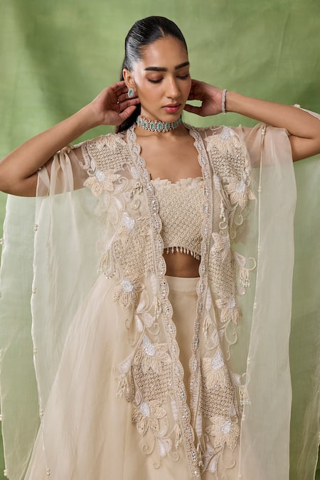 Shop_Awigna_Ivory Organza, Net Embroidery, Sequins, Beads, Freya Floral Cape Lehenga Set _Online_at_Aza_Fashions