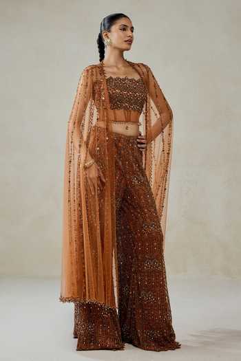 Nitika Gujral_Gold Satin, Net Sequins, Beads, Stones Hand Embellished Cape Sharara Set _at_Aza_Fashions