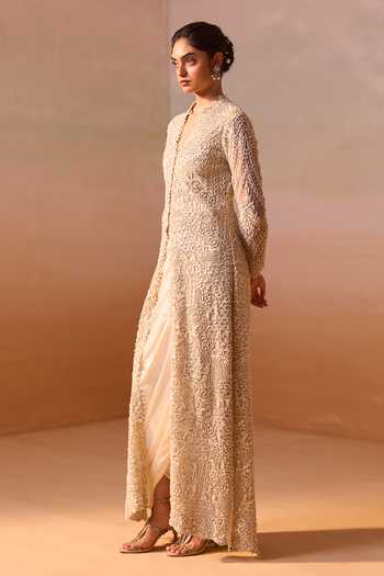 Shop Nitika Gujral Ivory Satin, Net V-neck Embroidered Long Jacket And Draped Skirt Set Online at Aza Fashions Shop_Nitika Gujral_Ivory Satin, Net V-neck Embroidered Long Jacket And Draped Skirt Set _Online_at_Aza_Fashions