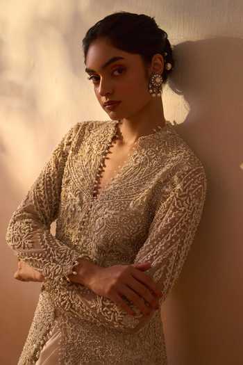 Nitika Gujral Ivory Satin, Net V-neck Embroidered Long Jacket And Draped Skirt Set at Aza Fashions Nitika Gujral_Ivory Satin, Net V-neck Embroidered Long Jacket And Draped Skirt Set _at_Aza_Fashions
