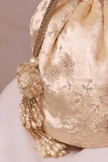 Amyra_Off White Sequins, Beads, Pearls, Tassels Suki Velvet Embroidered Potli _at_Aza_Fashions