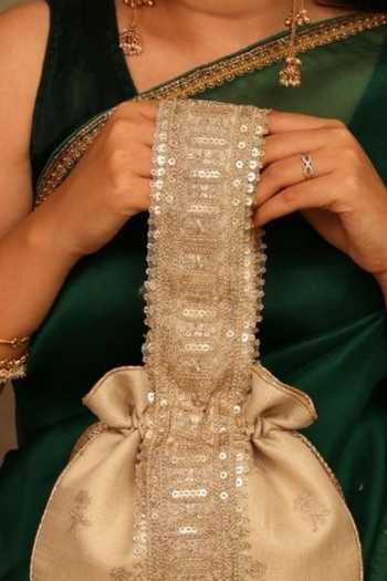 Amyra Beige Embroidery, Sequins, Beads, Zari, Tassels, Metallic Thread Arohi Potli at Aza Fashions Amyra_Beige Embroidery, Sequins, Beads, Zari, Tassels, Metallic Thread Arohi Potli _at_Aza_Fashions