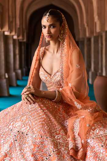 ANGAD SINGH Orange Silk Sweetheart Neck Suraj Mirror Embroidered Raw Lehenga Set at Aza Fashions ANGAD SINGH_Orange Silk Sweetheart Neck Suraj Mirror Embroidered Raw Lehenga Set _at_Aza_Fashions