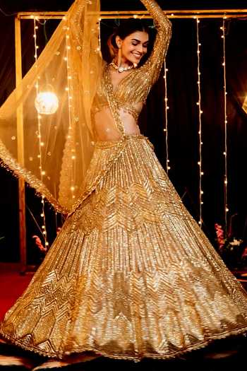 Shop Isa By Dolly Wahal Gold Net Sequins, Cut Work V-neck Icarus Embroidered Lehenga Set Online at Aza Fashions Shop_Isa By Dolly Wahal_Gold Net Sequins, Cut Work V-neck Icarus Embroidered Lehenga Set _Online_at_Aza_Fashions