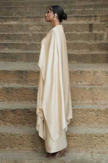 Shop Eraaya by Ratika J Beige Silk, Satin Shawl Neck Embroidered Cape Top With Skirt Online at Aza Fashions Shop_Eraaya by Ratika J_Beige Silk, Satin Shawl Neck Embroidered Cape Top With Skirt _Online_at_Aza_Fashions