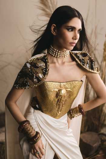 ASHNA VASWANI Gold Crepe, Chanderi, Satin Metallic Thread Bandeau Neck Cape And Corset Set Online at Aza Fashions ASHNA VASWANI_Gold Crepe, Chanderi, Satin Metallic Thread Bandeau Neck Cape And Corset Set _Online_at_Aza_Fashions