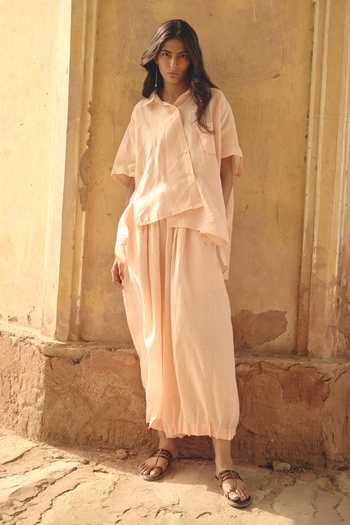 Shop Nirvanaa Peach Linen Button-down Neck Amara Asymmetric Shirt at Aza Fashions Shop Nirvanaa_Peach Linen Button-down Neck Amara Asymmetric Shirt _at_Aza_Fashions