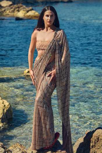 Nitika Gujral Gold Satin, Net Bandeau Neck Champagne Crystal Pre-draped Saree With Blouse at Aza Fashions Nitika Gujral_Gold Satin, Net Bandeau Neck Champagne Crystal Pre-draped Saree With Blouse _at_Aza_Fashions